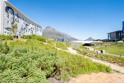 a retaining wall with a mural on the side of a building at 729 Riverlands - Lux Studio Apartment in Cape Town