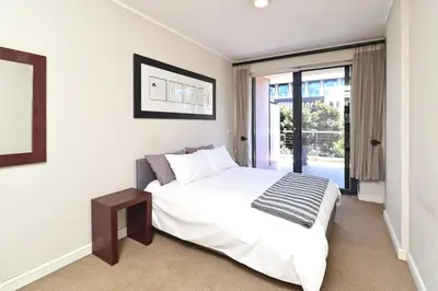 a bedroom with a large white bed and a window at City Vibes and Mountain Highs 2 Bed, 2 Bath Apart
