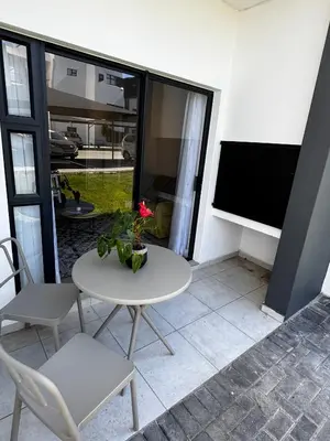 a white table and chairs in a room with a window at Flat in Security Estate - Zomerwind Apartments in Oakdale