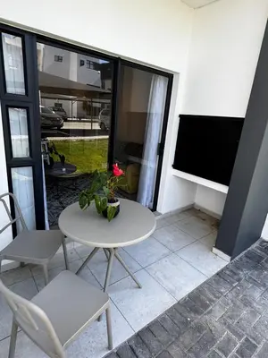 a white table and chairs in a room with a window at Flat in Security Estate - Zomerwind Apartments in Oakdale