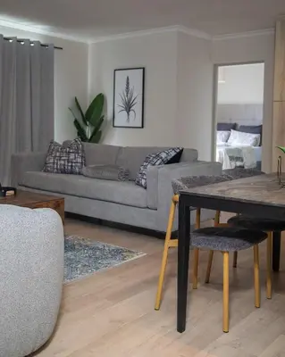 a living room with a couch and a table at Cape on Viola in Cape Town