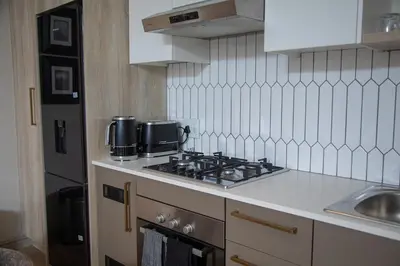 a kitchen with a stove top and a sink at Cape on Viola in Cape Town