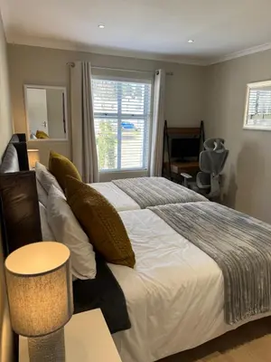 a bedroom with a large bed and a window at Montblanc 3 Bed 3 Bath House in residential security Estate in Stellenbosch