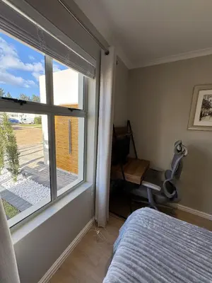 a bedroom with a window and a bed and a desk at Montblanc 3 Bed 3 Bath House in residential security Estate in Stellenbosch