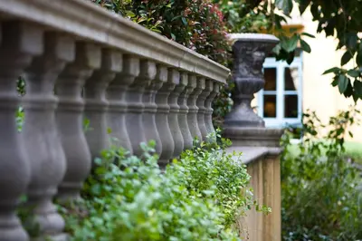 a stone wall with aotted plant on top of it at Franschhoek Country House & Villas in Franschhoek