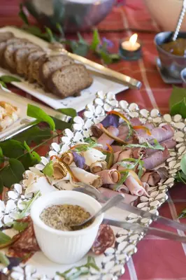a table with a plate of food on a table at Franschhoek Country House & Villas in Franschhoek