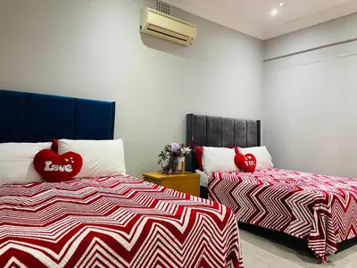 a bedroom with two beds with red hearts on them at Annika`s dormitory in claremont in Cape Town