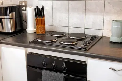 a stove top oven sitting on top of a kitchen counter at The Palm in Kraaifontein