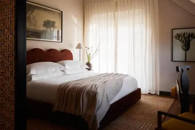 a bedroom with a large bed and a window at The Manor House at Colmant in Franschhoek