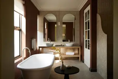 a bathroom with two sinks and a bath tub at The Manor House at Colmant in Franschhoek