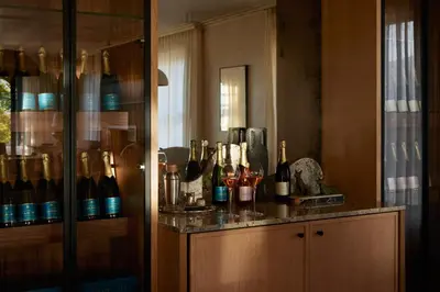 a room with a counter with bottles of wine at The Manor House at Colmant in Franschhoek