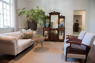 a living room with a couch and a table at River Manor Boutique Hotel by The Living Journey Collection in Stellenbosch