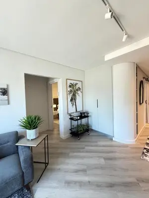 a living room with a couch and a table at Platform 123 - 2 On Tabak with onsite Parking in Paarl