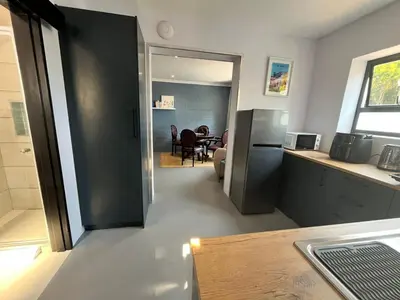 a kitchen and a dining room with a table at Pelikaan 5 in Stellenbosch
