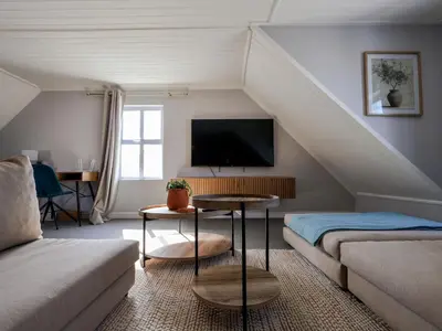 a living room with a couch and a tv at Salt & Butter in Hermanus