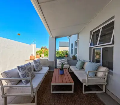 a patio with two couches and a table at Salt & Butter in Hermanus