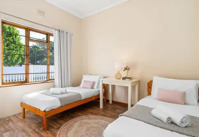 a bedroom with two beds and a window at Sea view holiday home in Kleinmond
