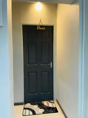 a black door with a welcome sign on it at A guesthouse & Dormitory beds Claremont in Cape Town