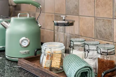 a cutting board with jars of spices on a kitchen counter at Coral Grove in Cape Town