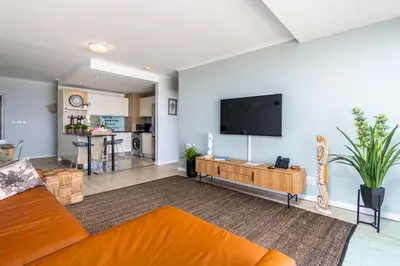 a living room with a flat screen tv on a wall at Blu Horizon in Cape Town