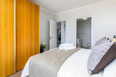 a bedroom with a large white bed with two pillows at Blu Horizon in Cape Town