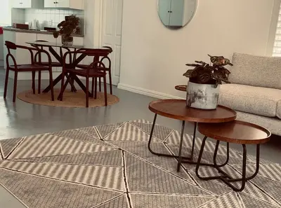 a living room with a table and a couch at Crescent House in Franschhoek