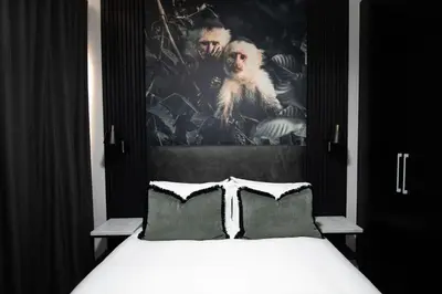 a bedroom with a bed with a picture on the wall at The Onyx Stellenbosch in Stellenbosch