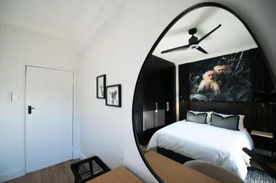 a bedroom with a large mirror over a bed at The Onyx Stellenbosch in Stellenbosch