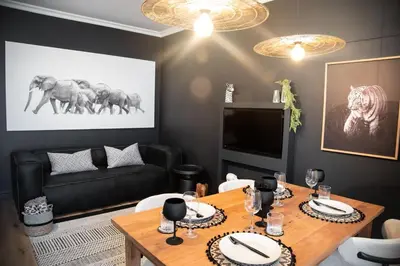 a living room with a table and a couch at The Onyx Stellenbosch in Stellenbosch