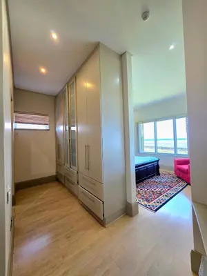 an empty room with a closet and a bed in it at Beachfront Golf Estate Escape in Strand in Strand