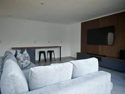 a living room with a white couch and a table at Kubata Diame B&B in Cape Town