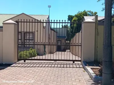 a gate in front of a house with a fence at The Hidden Gem in Oakdale