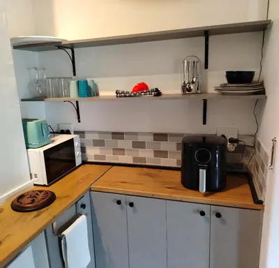 a kitchen with a counter top with a microwave at The Thatched Cottage in Eversdal