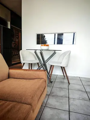 a living room with a table and two chairs at Comfy 1 Bedroom Flat in Thornton