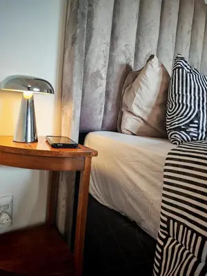 a hotel room with a bed with a lamp and a table at Comfy 1 Bedroom Flat in Thornton