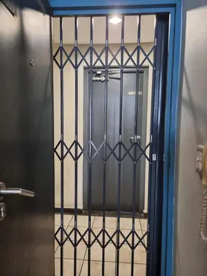 a door with a iron gate in a bathroom at Comfy 1 Bedroom Flat in Thornton
