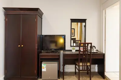 a room with a desk with a tv and a computer at Cumberland Hotel & Conference Centre Worcester in Worcester