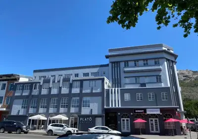 a large building with cars parked in front of it at Finch Nest Self Catering in Paarl