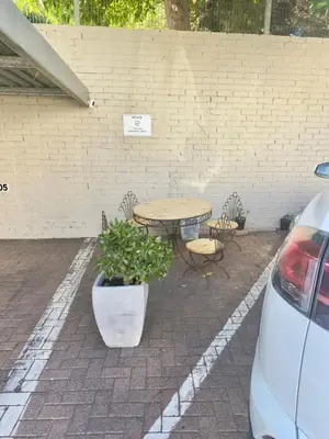 a patio with a table and chairs and a table and a table and chairs at Finch Nest Self Catering in Paarl
