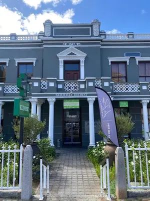 a blue building with a sign in front of it at Finch Nest Self Catering in Paarl