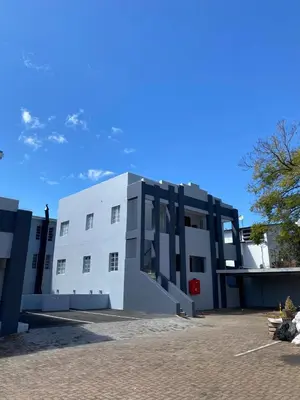 a large white building with a blue sky in the background at Finch Nest Self Catering in Paarl