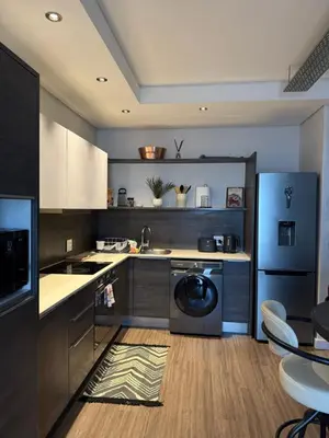 a kitchen with a washing machine in the middle at Enzo Stay -The Matrix 505 , Century City in Cape Town