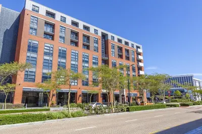a large brick building with a street in front of it at Enzo Stay -The Matrix 505 , Century City in Cape Town
