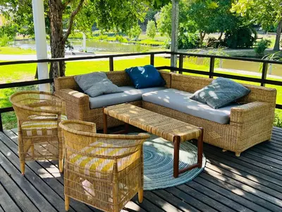 a couch and two chairs on a deck at Monkscowl Estate in Stellenbosch