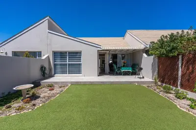 a house with a yard with green grass at The Woodbridge Hideaway in Cape Town