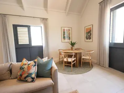 a living room with a couch and a table at Cornercade | Unit 1 in Hermanus