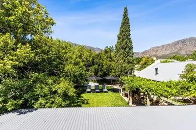 an aerial view of the backyard of a house with a tree at Pepler House in Franschhoek