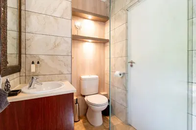 a bathroom with a toilet and a sink and a shower at Avemore Eikehoff no 2 in Stellenbosch