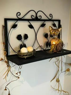 a shelf with a cat figurine and balls on it at Boutique Inn - Quintessence in Gordonʼs Bay
