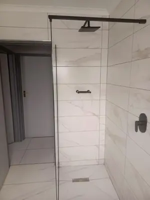 a shower with a glass door in a bathroom at Capetown Adilo Villa in Cape Town